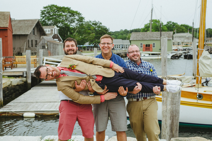 groomsmen holding groom