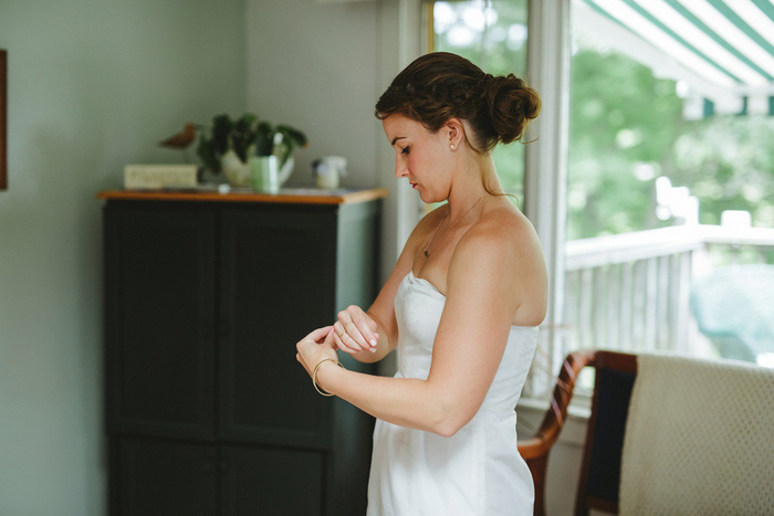 bride putting on bracelet