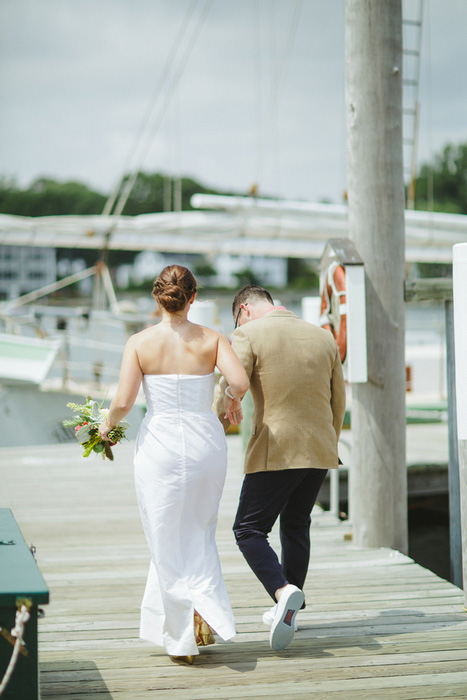 bride and groom walking on dock