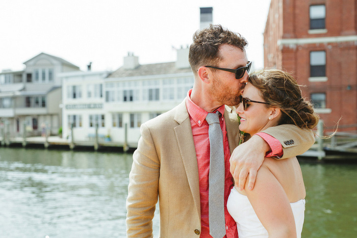 groom kissing bride on forehead