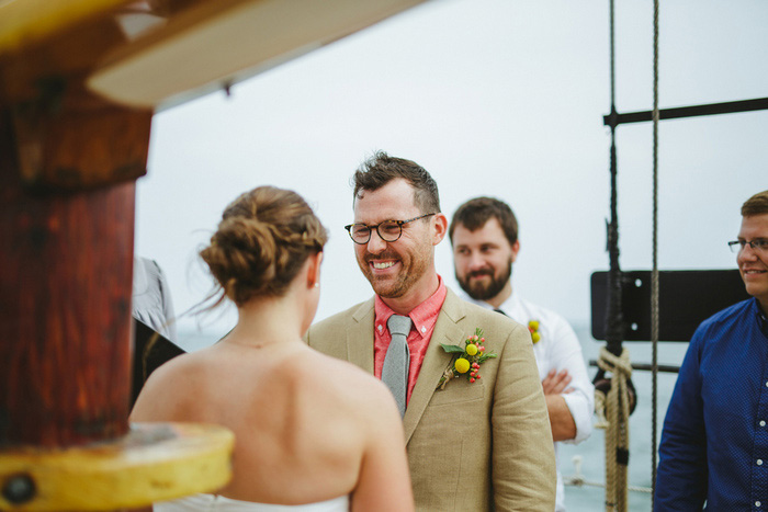 groom smiling at bride during ceremony