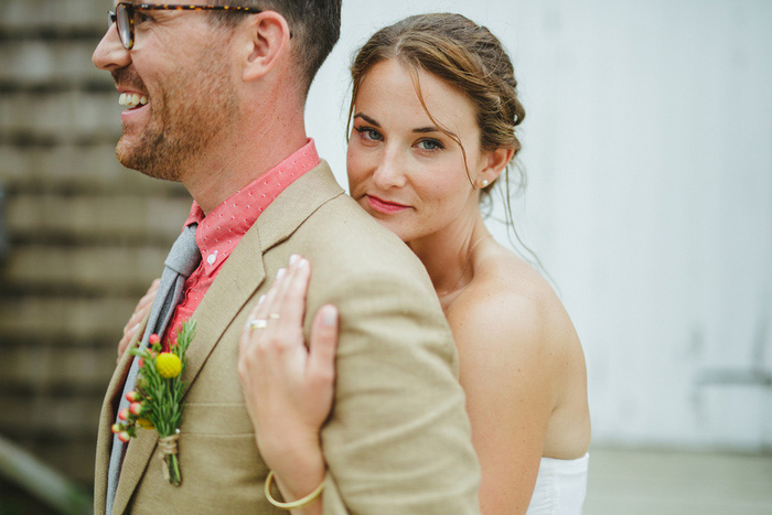 bride hugging groom from behind