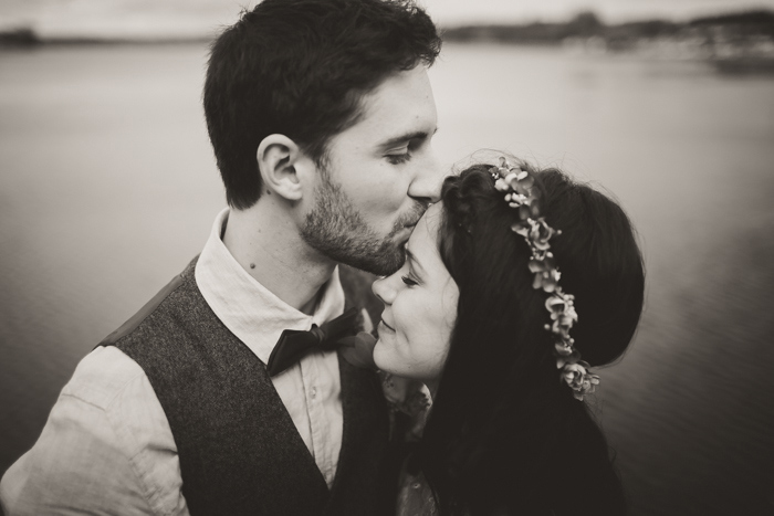 groom kissing bride's forehead