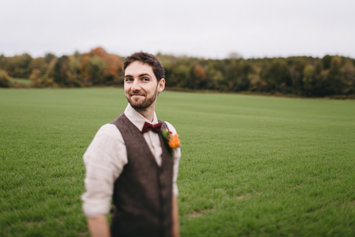 casual groom in vet and bow tie