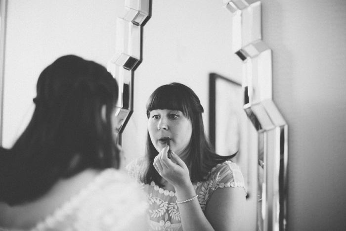 bride putting on lipstick