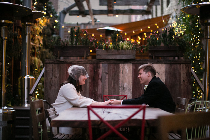 bride and groom sitting on patio