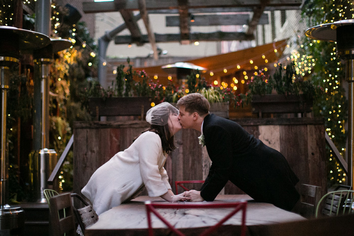 bride and groom kissing on patio