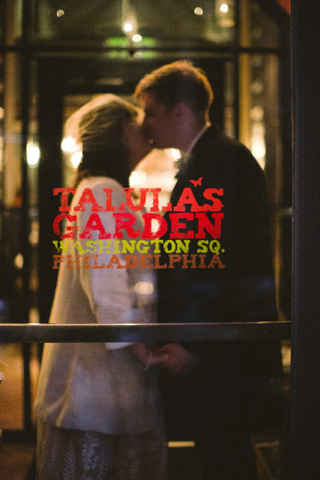 bride and groom kissing in restaurant