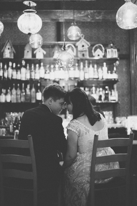 bride and groom sitting at the bar