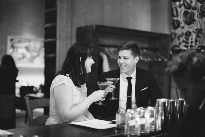 bride and groom having a drink at the bar