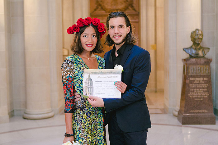 bride and groom with marriage certificate