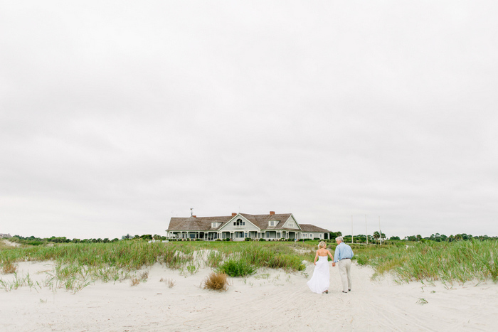 bride and groom walking up to club house