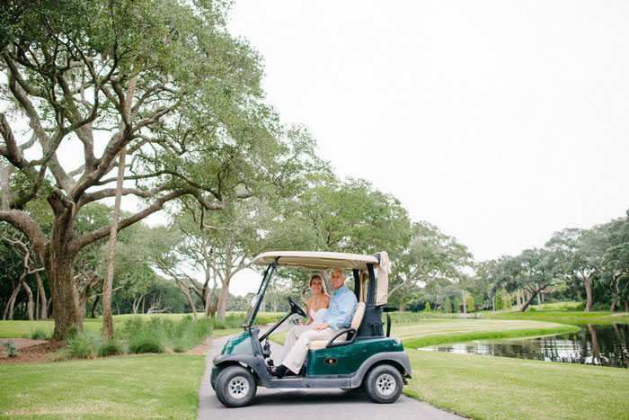 bride and groom on golf cart