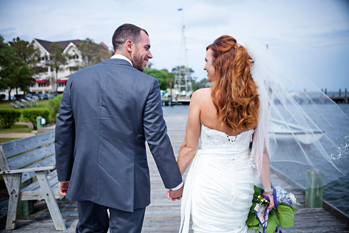 bride and groom walking down dock