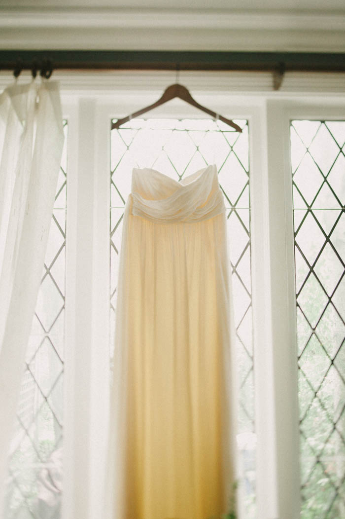 wedding dress hanging in the window