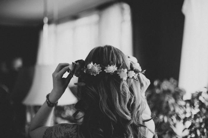 bride adjusting her flower crown