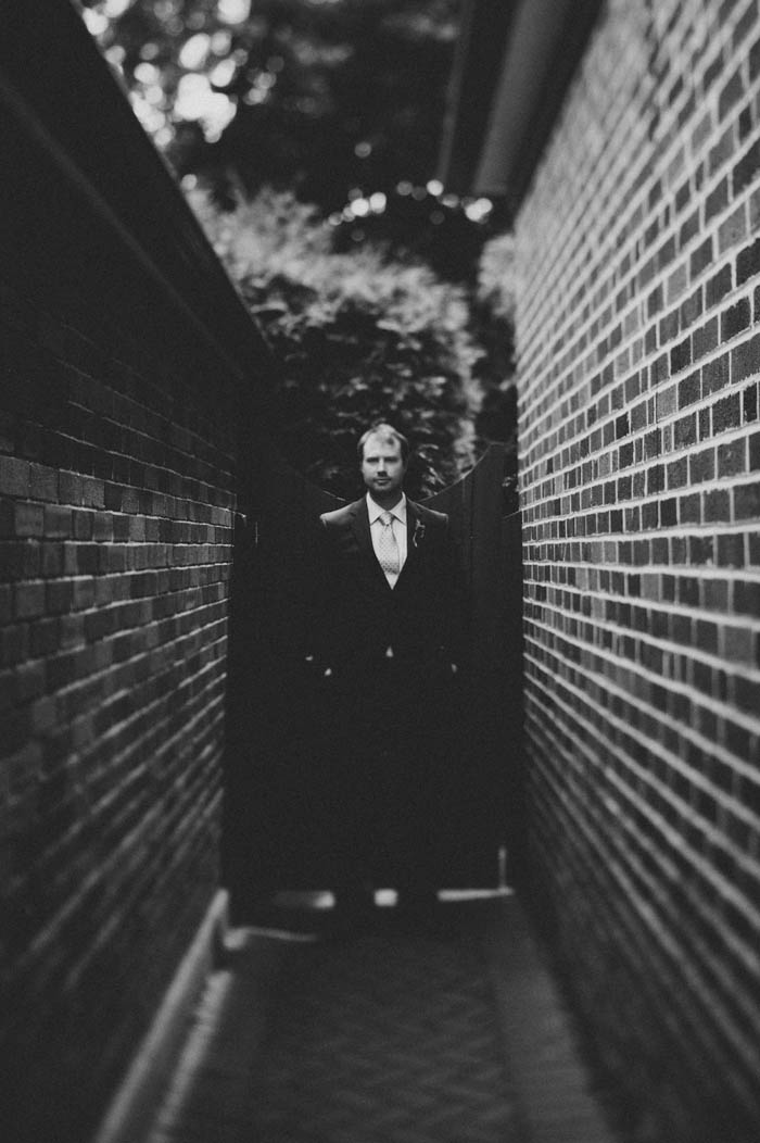 groom portrait by side of house