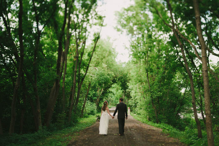 bride and groom walking down dirt road