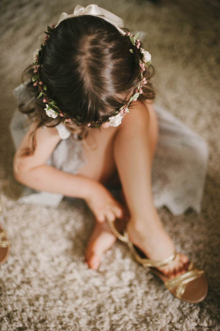 flower girl putting on sandals