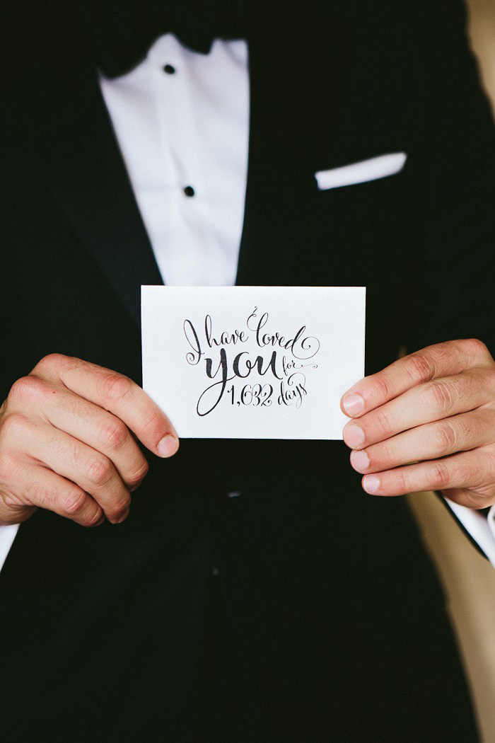 groom holding card