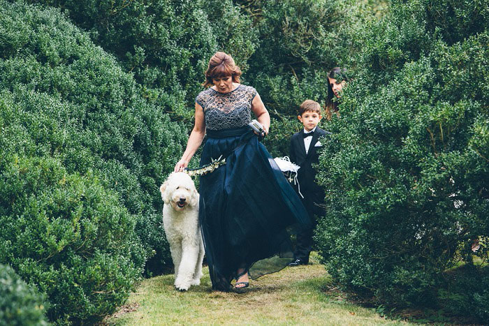 mother of the bride walking down the aisle with dog