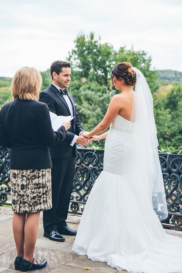 bride and groom holding hands during ceremony