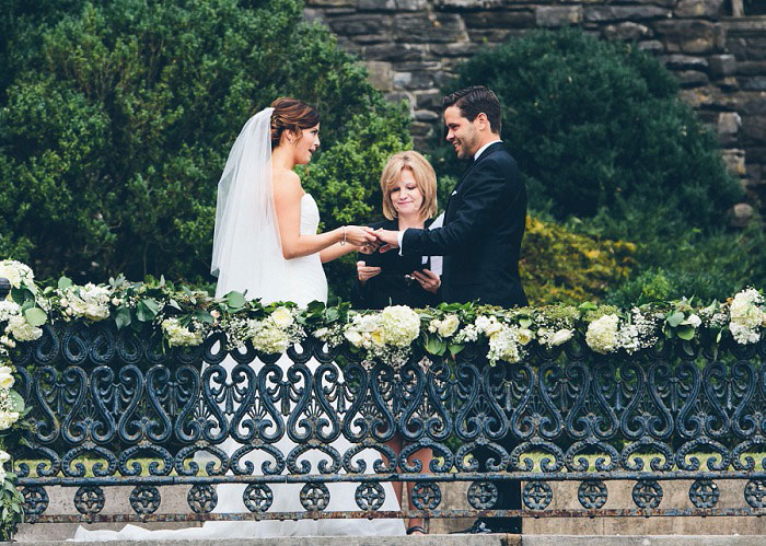 bride and groom holding hands during ceremony