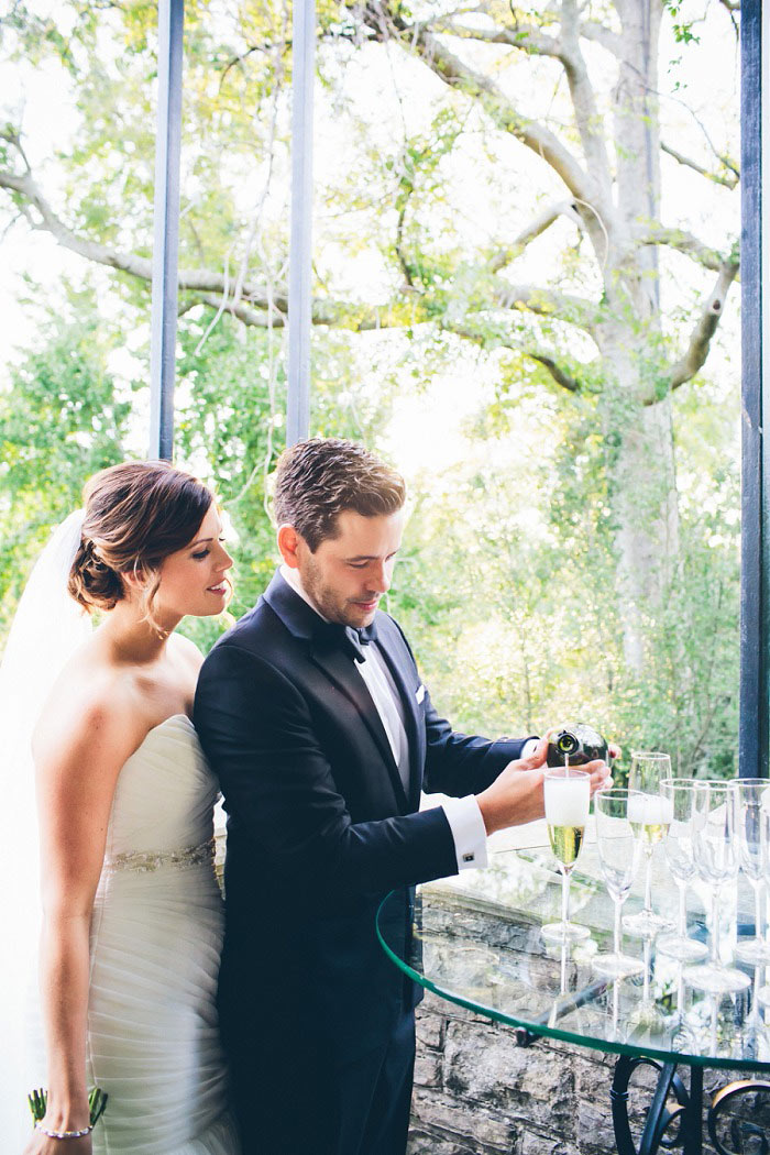 groom pouring champagne