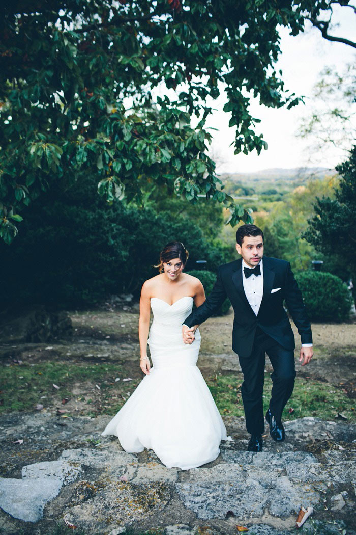 bride and groom walking up hill