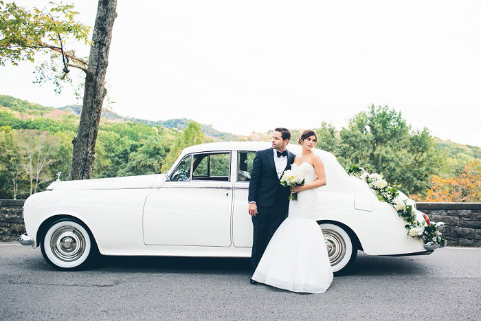 bride and groom portrait in front of vintage car