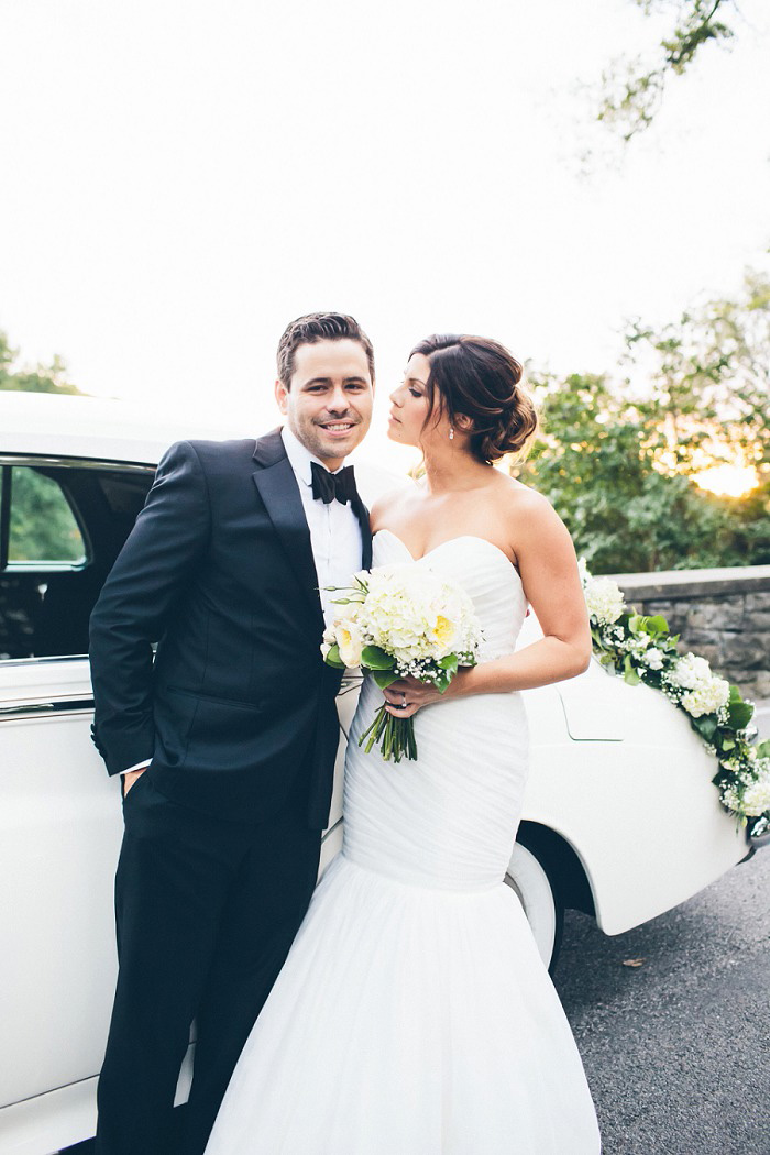 bride and groom in front of vintage car