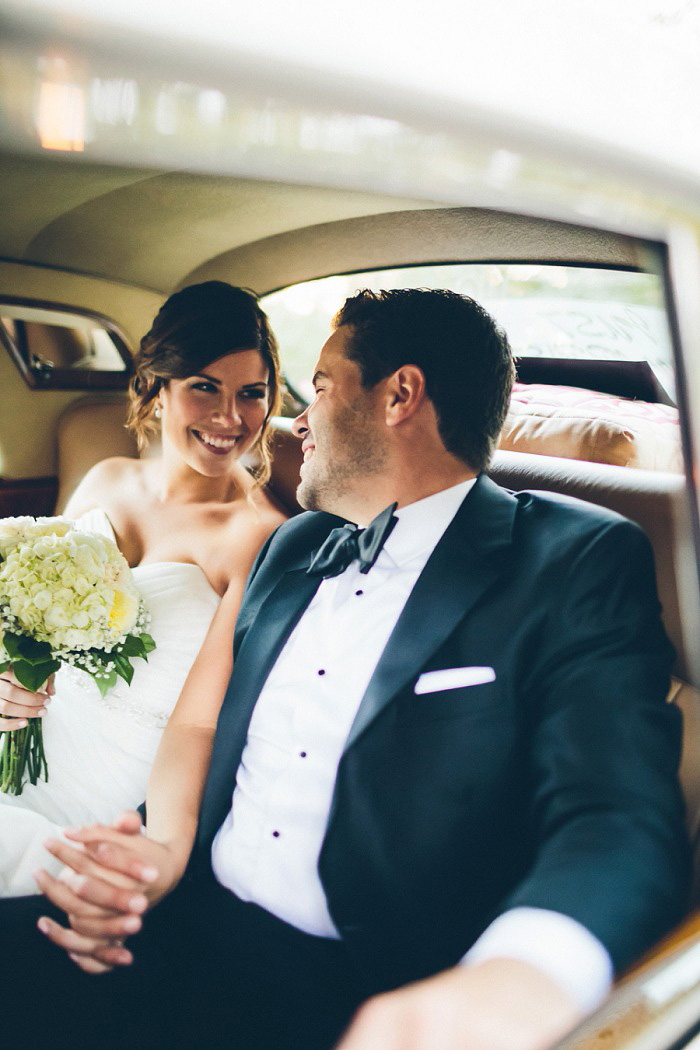 bride and groom in vintage car