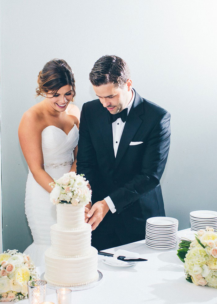 bride and groom cutting the cake