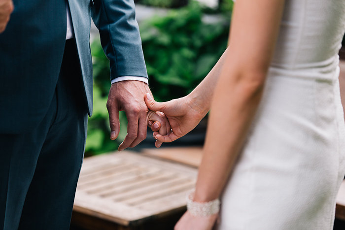 bride and groom holding hands during ceremony