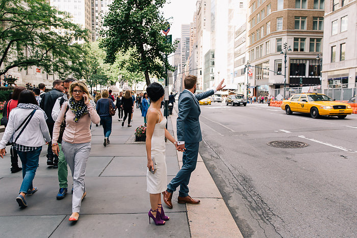 bride and groom hailing a cab