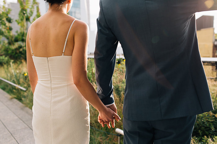 bride and groom holding hands