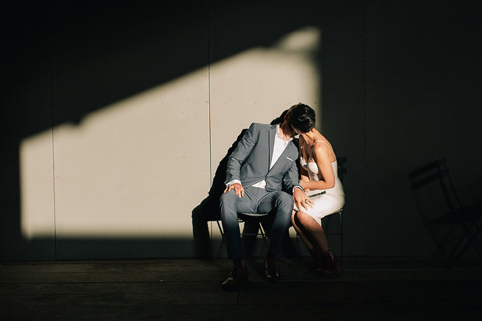 bride and groom kissing in the shadows