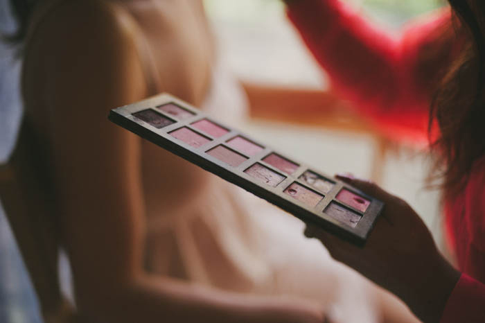 make-up artist holding eyeshadow paelette