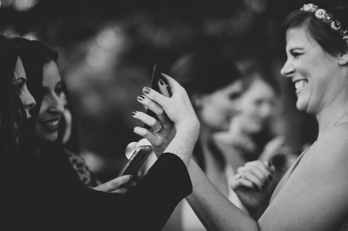 wedding guests looking at phone