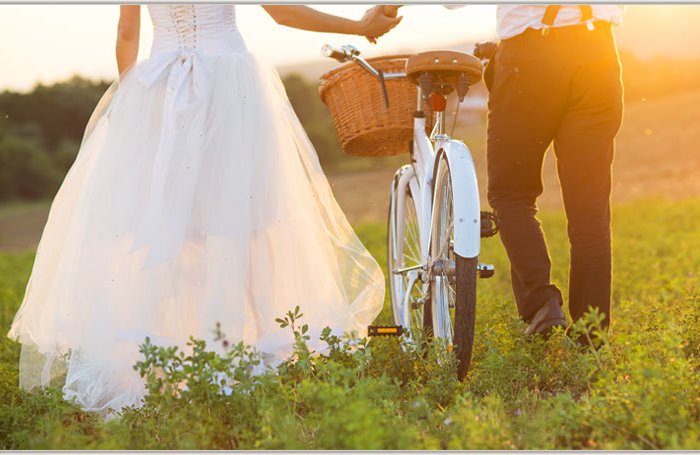 Bride and groom with a white wedding bike