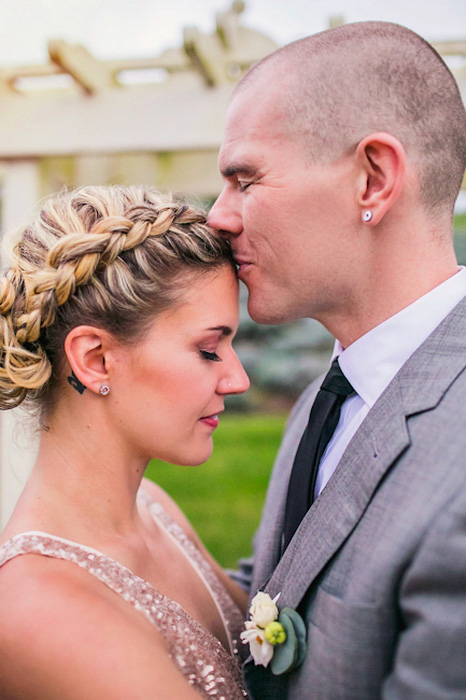 groom kissing bride's forehead