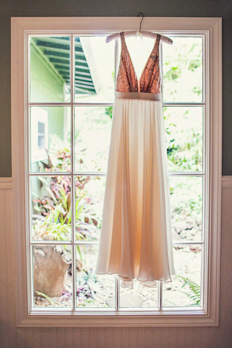 wedding dress hanging in window