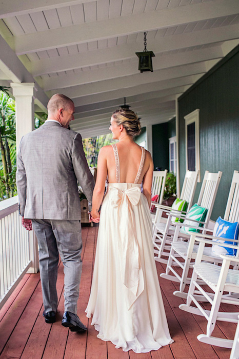 bride and groom walking on porch