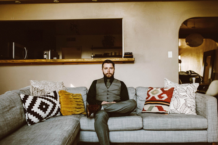 groom sitting on couch