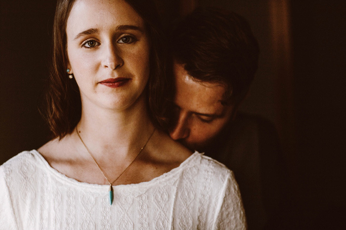 groom kissing bride's shoulder