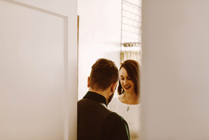 groom helping bride get ready