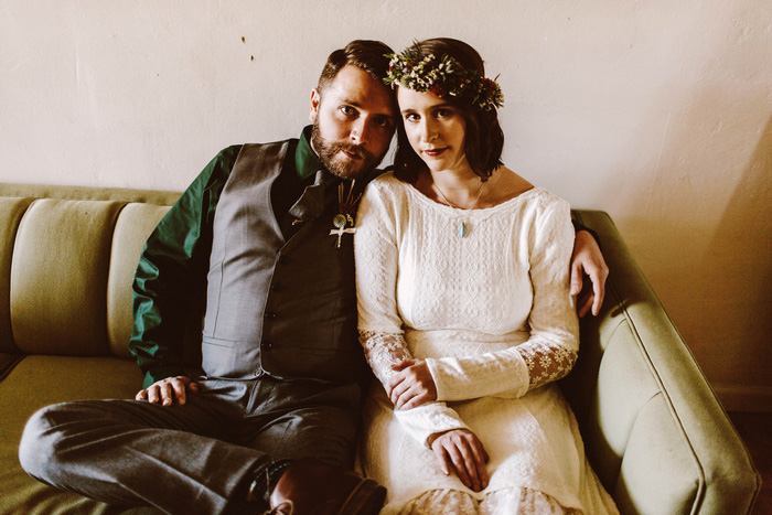 bride and groom sitting on couch