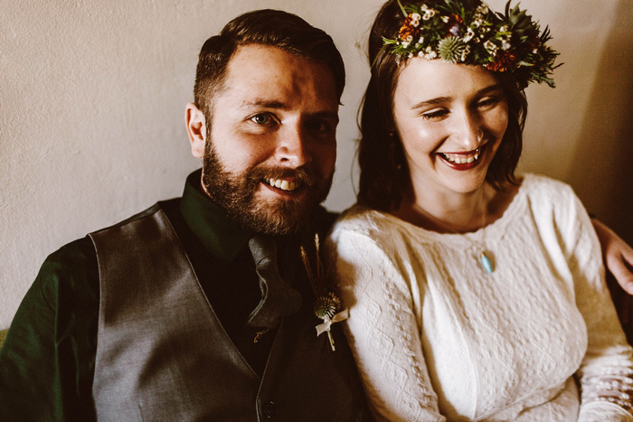 bride and groom laughing on couch