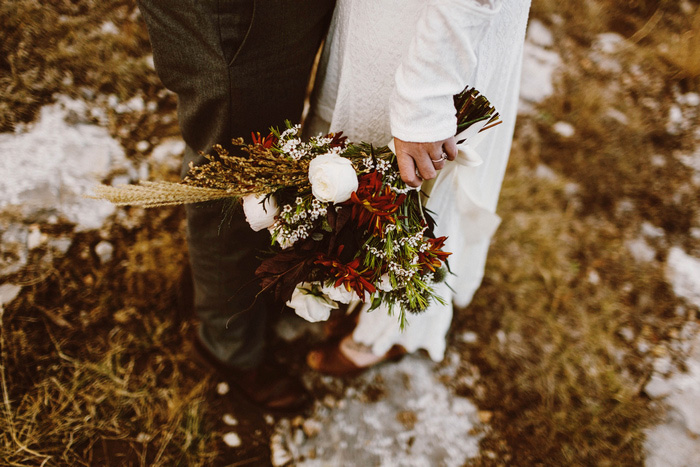 bride carrying fall wedding bouquet