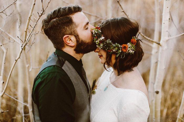 groom kissing bride's forehead